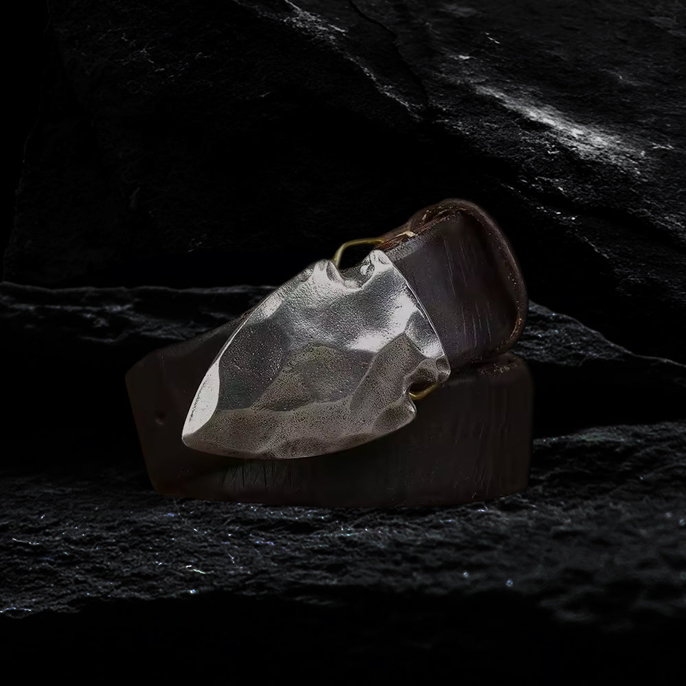 Pfeilspitzen-Schnalle aus Edelstahl am Echtleder Gürtel auf dunklem Steinfelsen